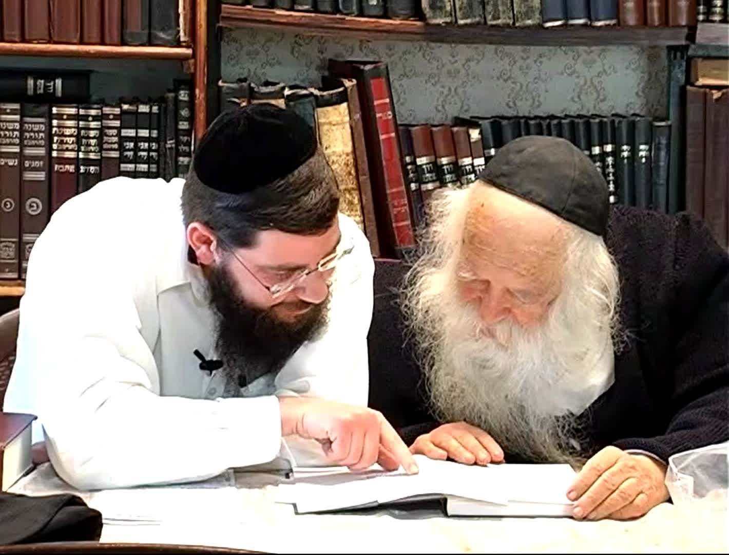 Rav Uri Tiger reviewing a Torah text with Rav Chaim Kanievsky